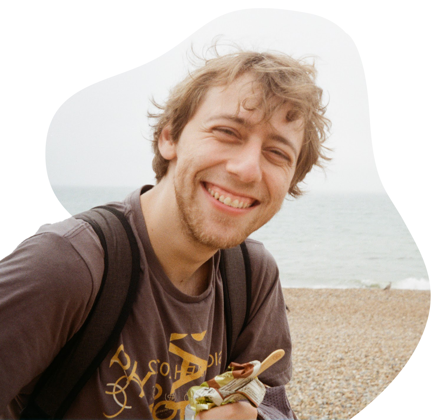 Portrait of me! Short blonde hair, chaotic SIGGRAPH shirt, beach in the background.